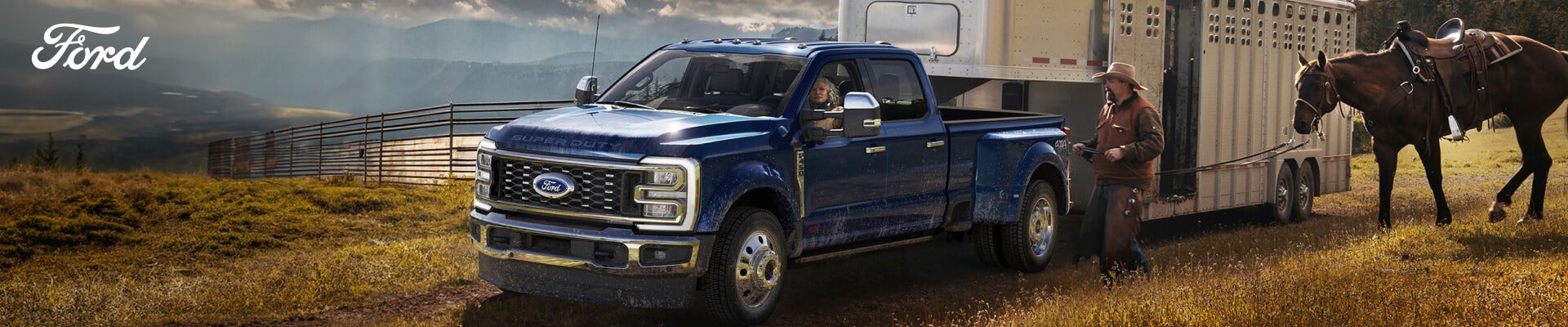 2026 Ford Super Duty F-450 King Ranch in Argon Blue Metallic, with a driver and rancher leading a saddled horse by trailer.